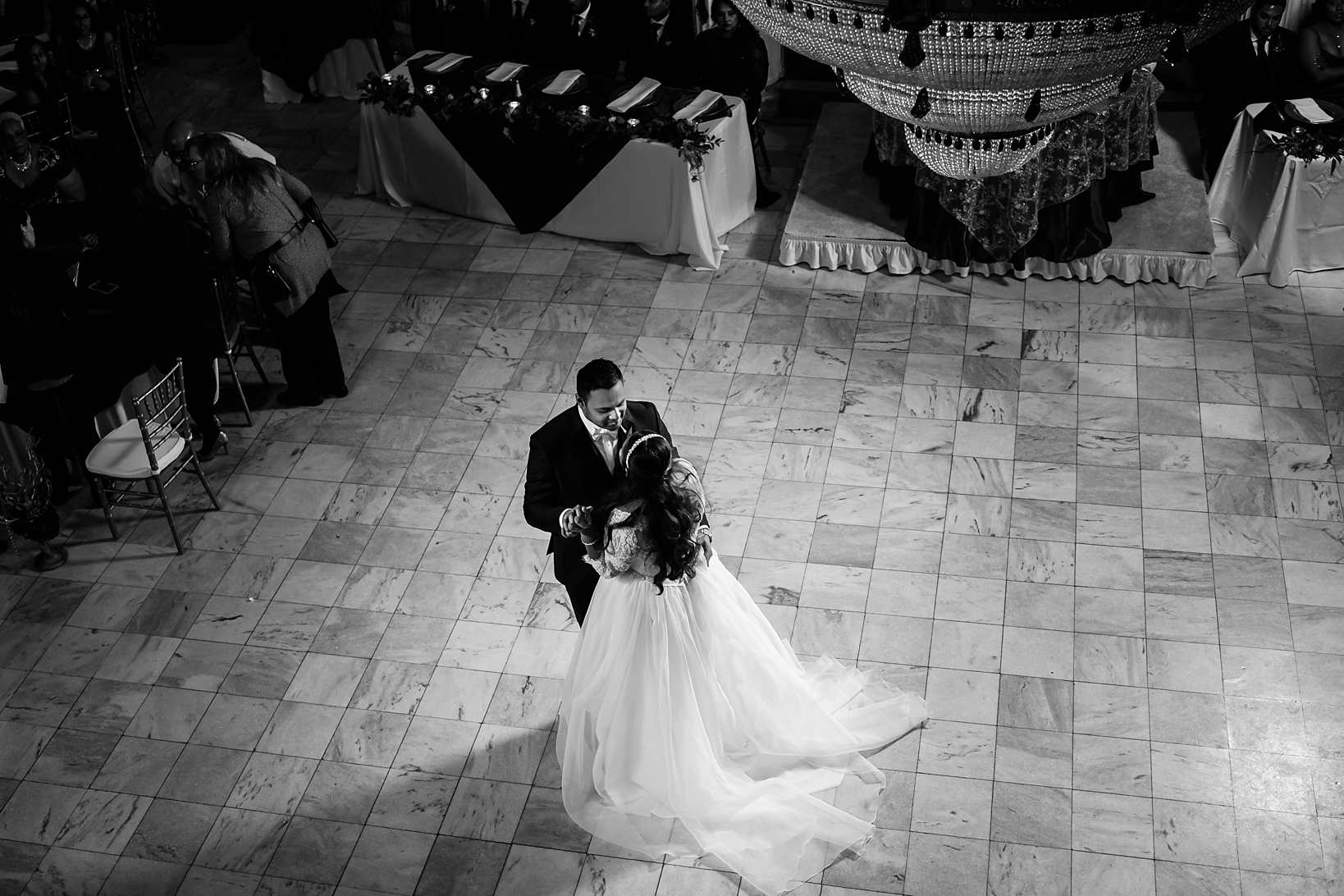 The Bride and Groom share their first dance in this fairy tale setting in black and white by Sarah & Ben Photography