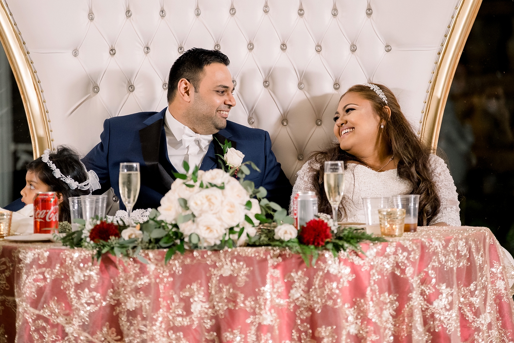Bride and Groom sharing a laugh at their sweetheart table by Sarah & Ben Photography