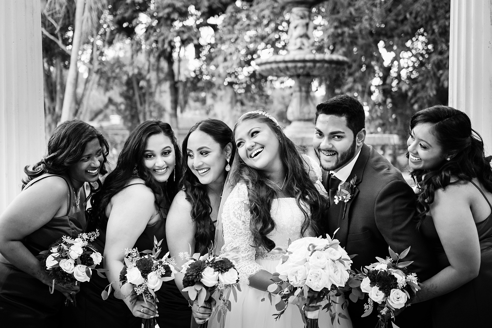 A candid moment between the bride and her bridal party by Sarah & Ben Photography