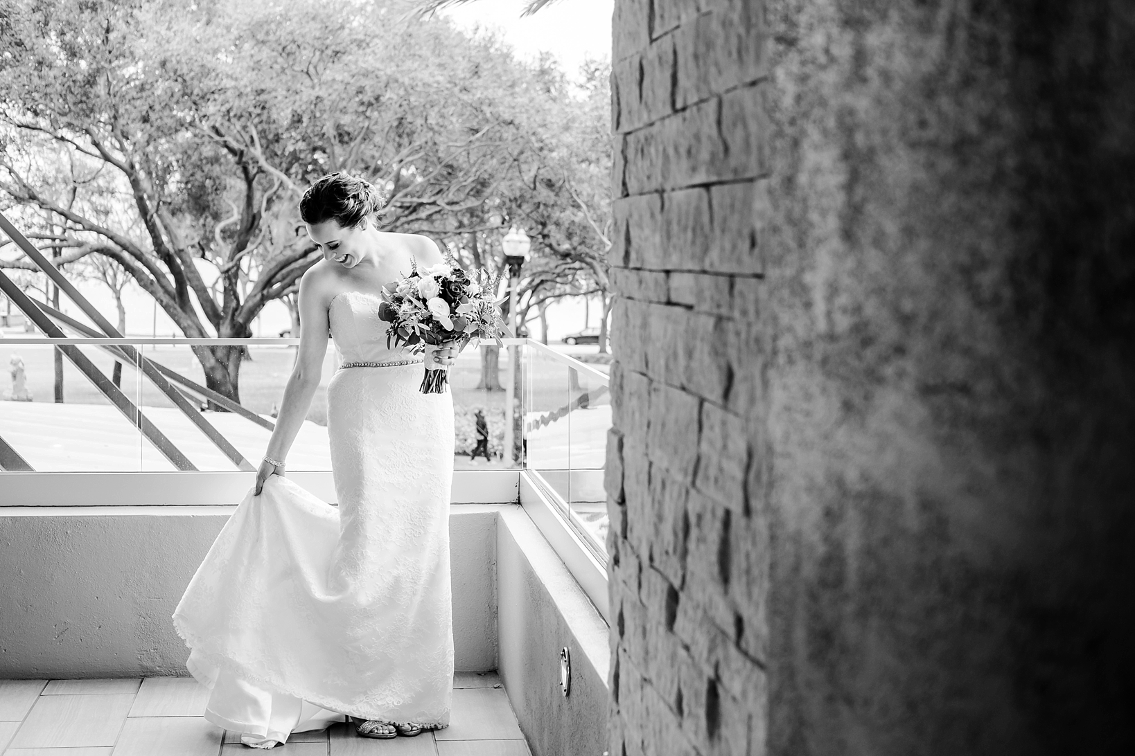 The bride on a balcony before the first look in black and white