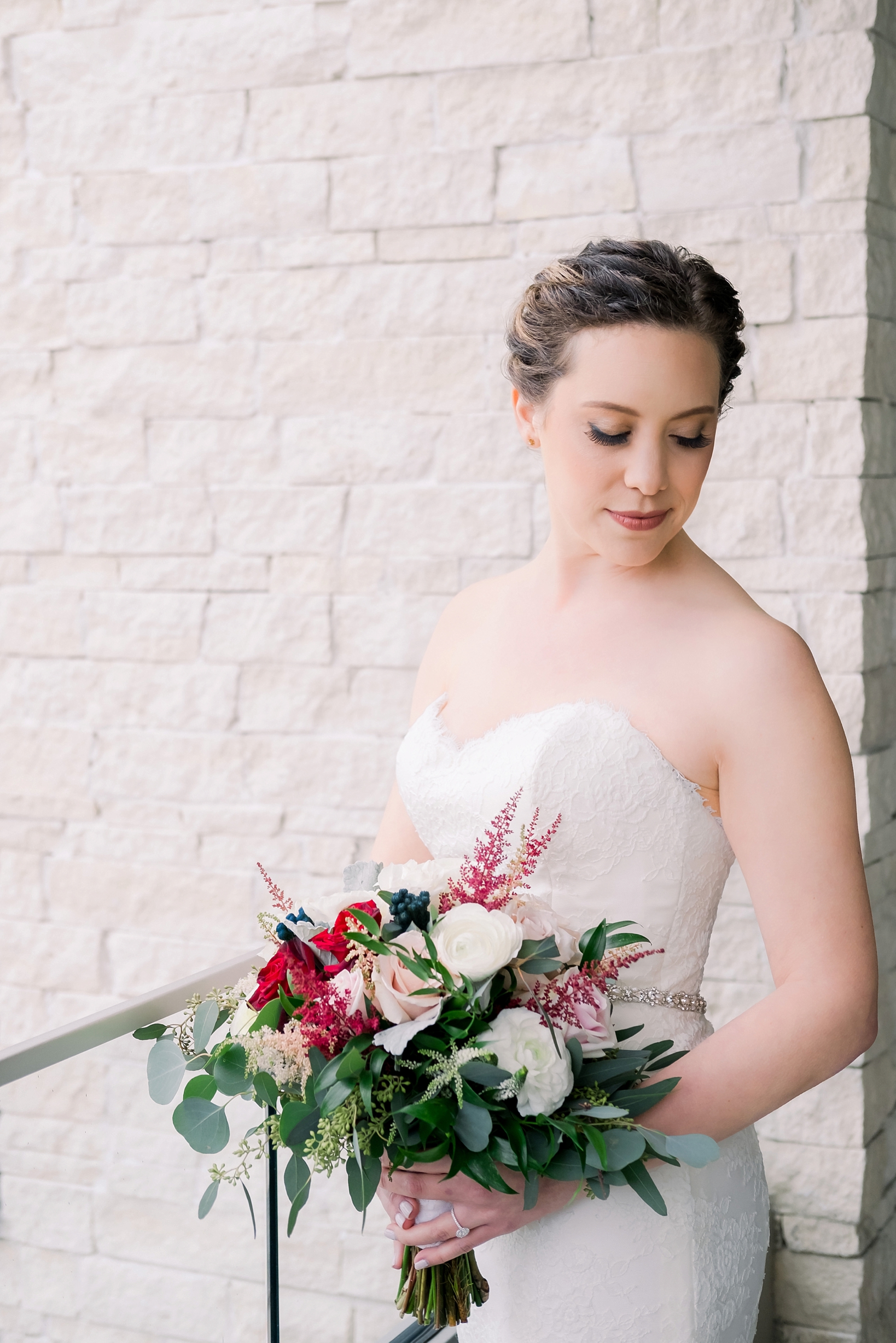 A bridal portrait of a Bride in front of a brick wall by Sarah & Ben Photography