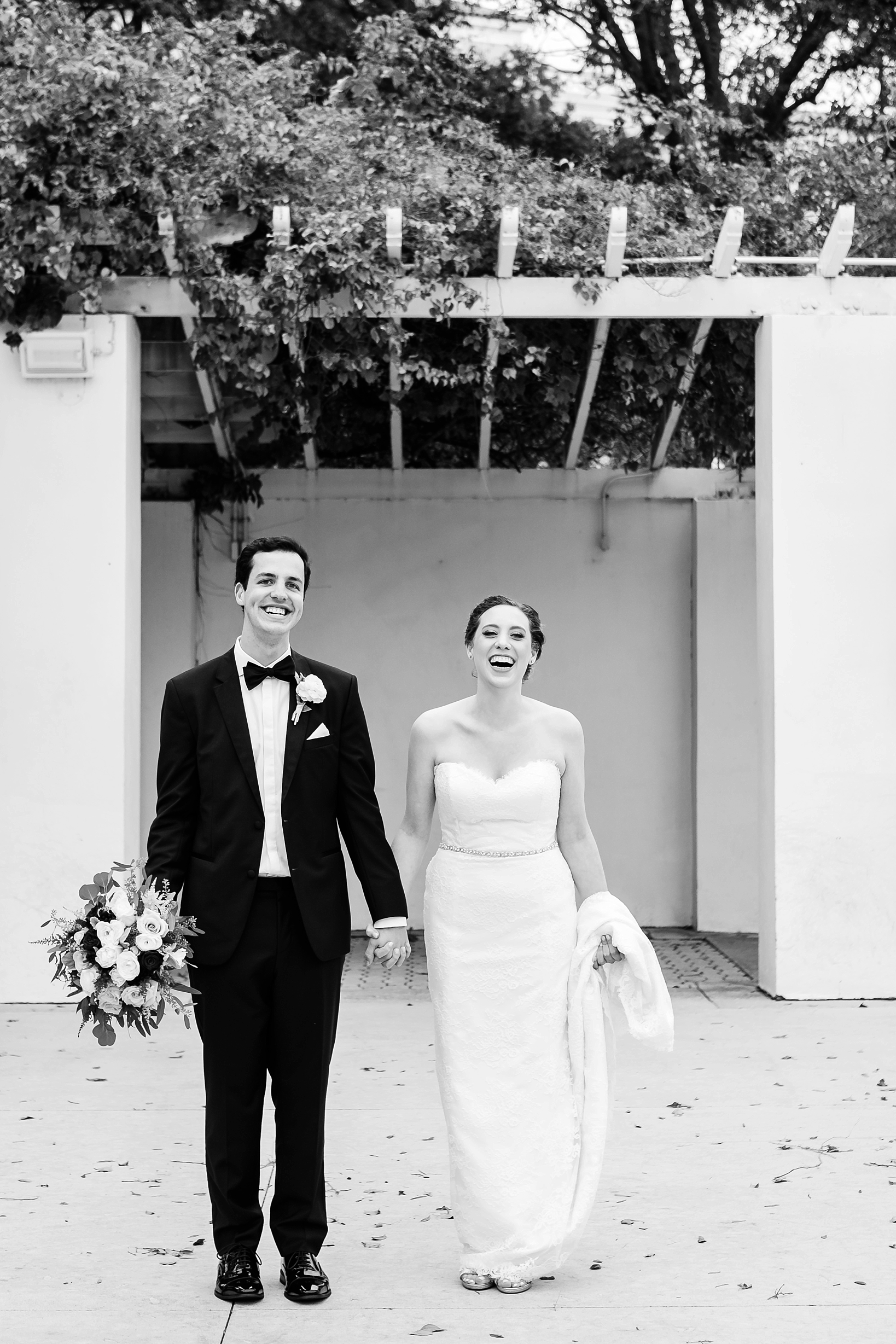 A classic black and white photo of the wedding couple laughing on their special day by Sarah & Ben Photography