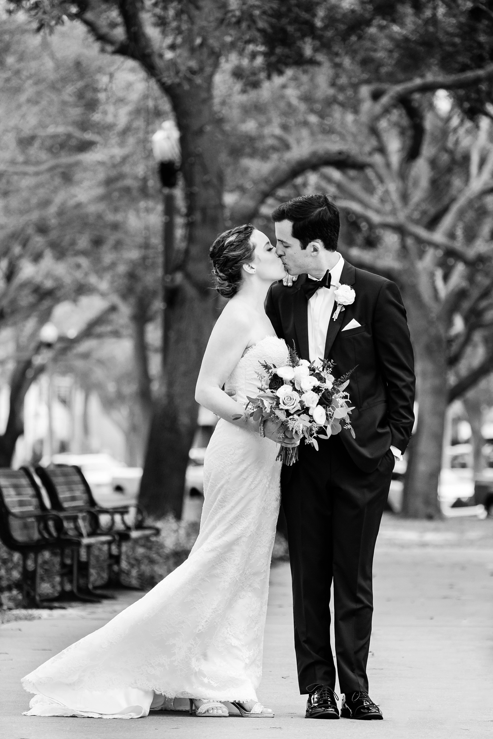 Bride and Groom share a kiss in the park in St. Petersburg, Florida by Sarah & Ben Photography
