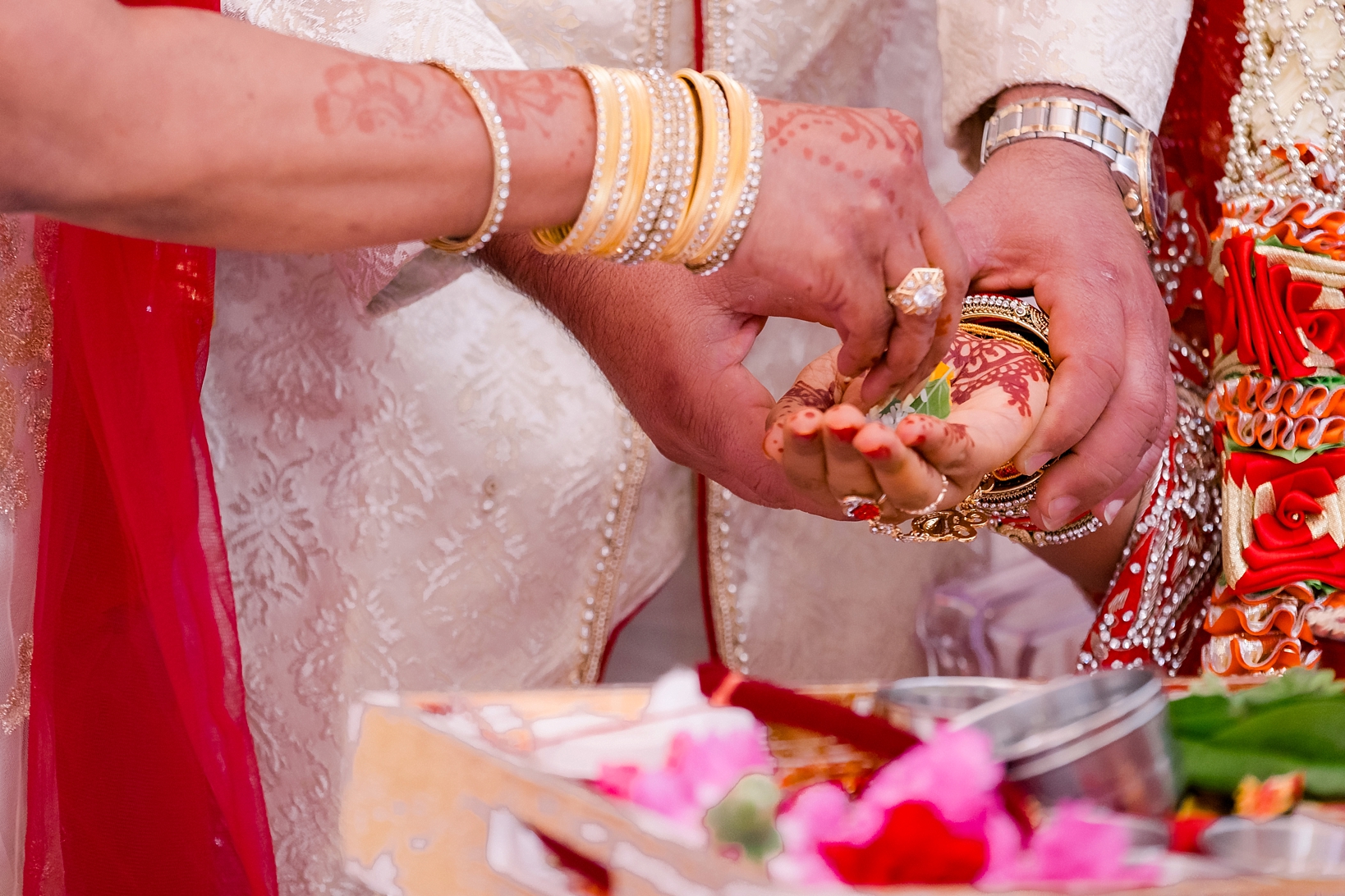 detailed image of the henna covered hands of the bride and groom