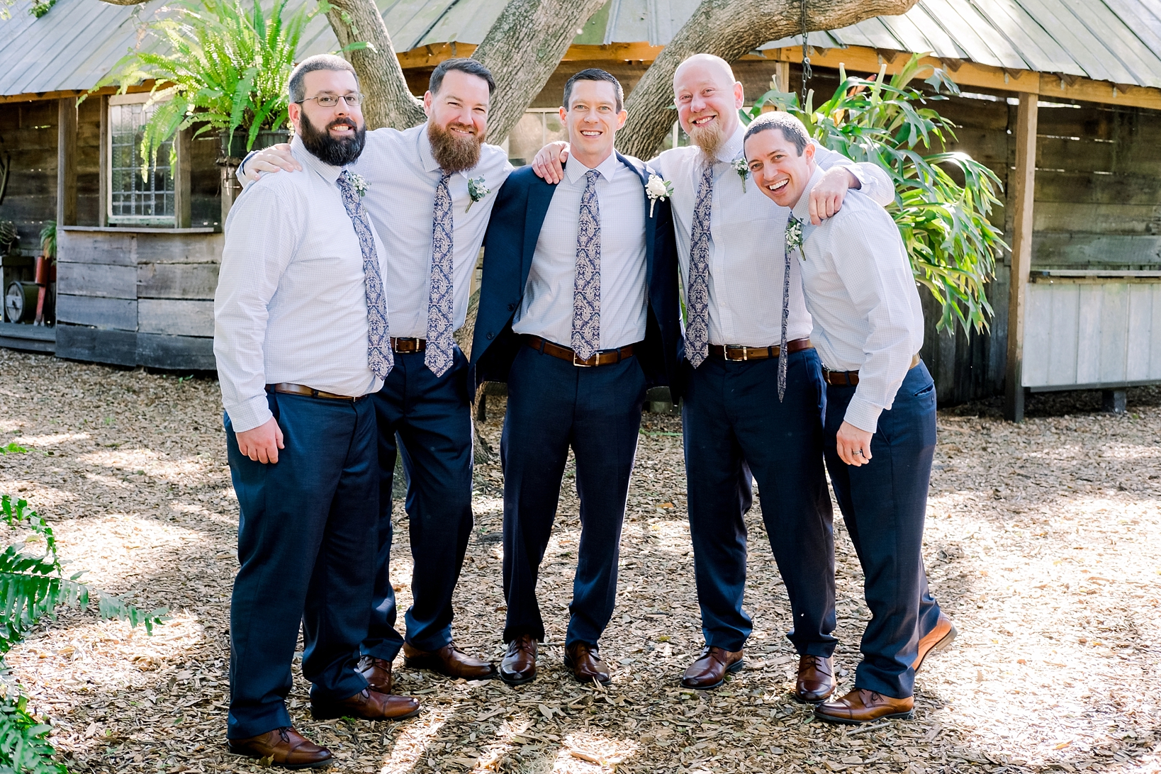Groom and his groomsmen in a candid moment before his Cross Creek Ranch wedding day