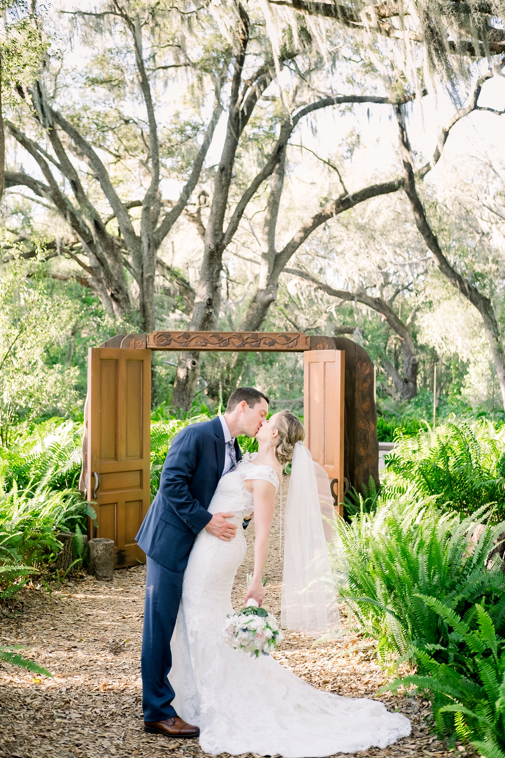 Groom dips his Bride for a kiss after their Cross Creek Ranch wedding