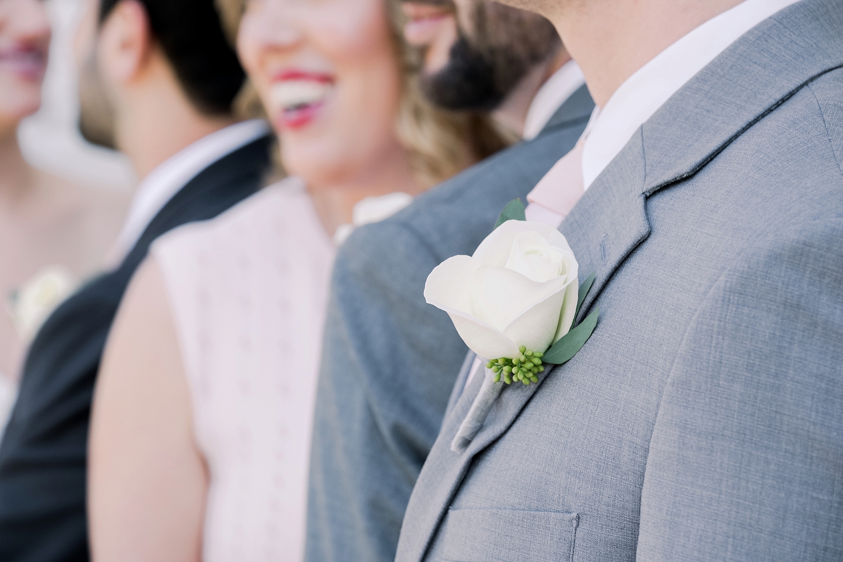 Detail shot of the Groomsmen's white floral boutonnière