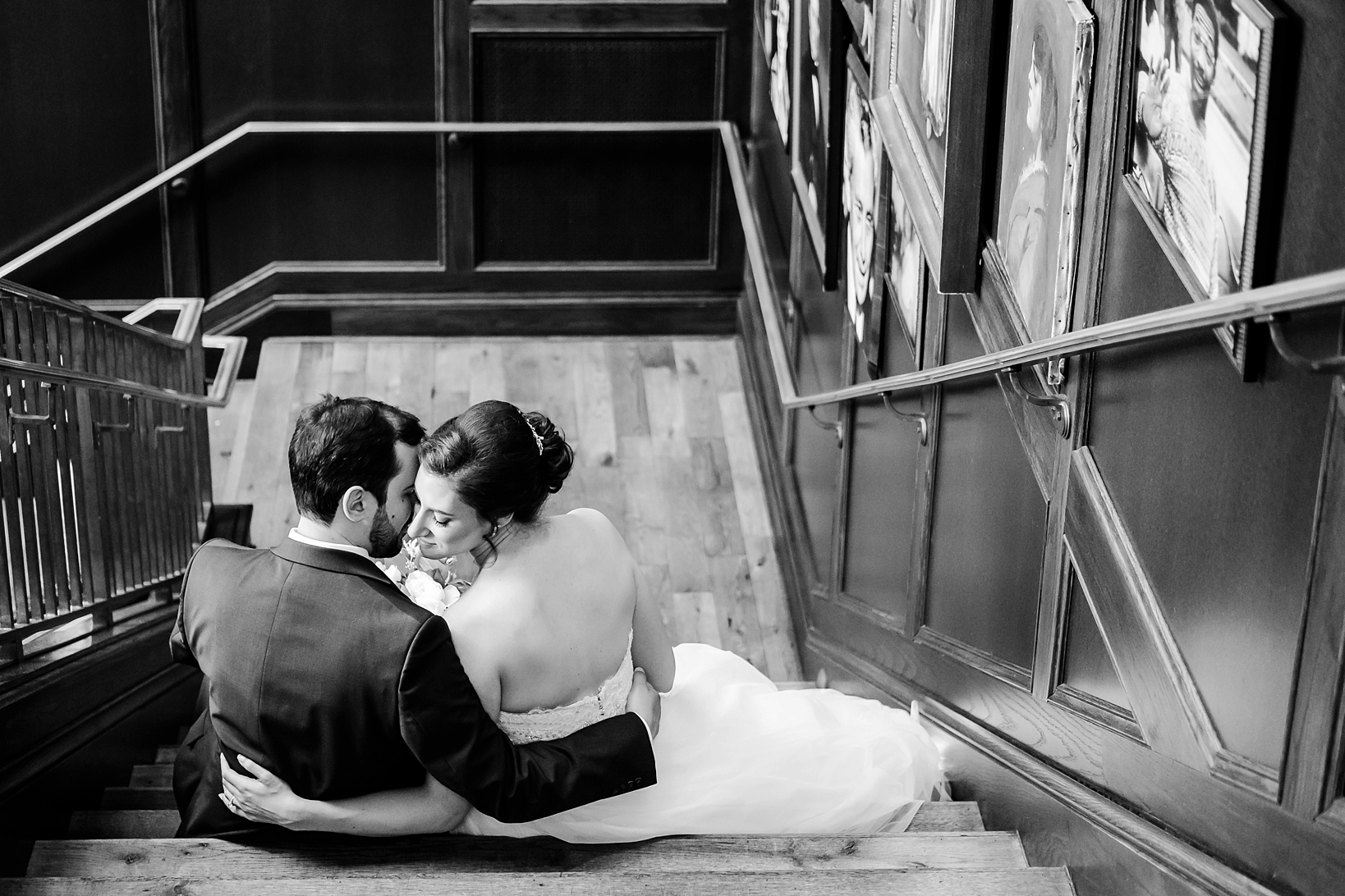 Bride and Groom snuggle up on the steps before their wedding reception