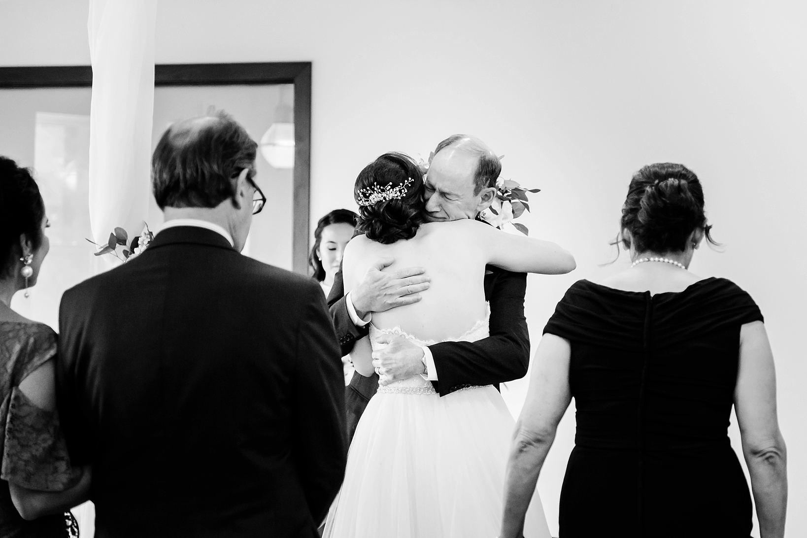 Dad hugs his daughter during the wedding ceremony of her oxford exchange wedding
