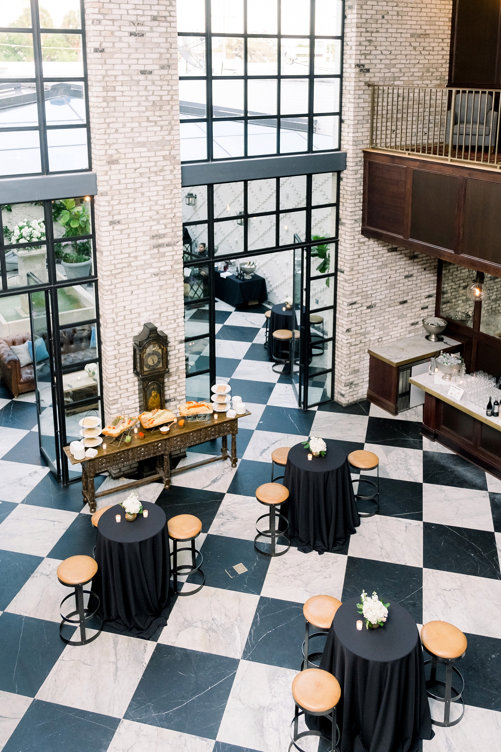 The wedding reception venue at the Oxford exchange complete with checkerboard floor and wooden stools