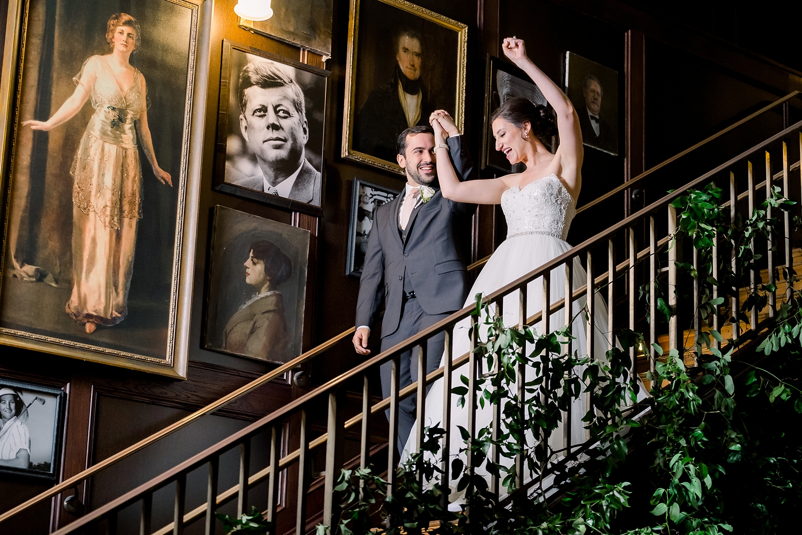 Newlyweds descend the stairs to join their guest during their reception at Oxford Exchange in Tampa, FL