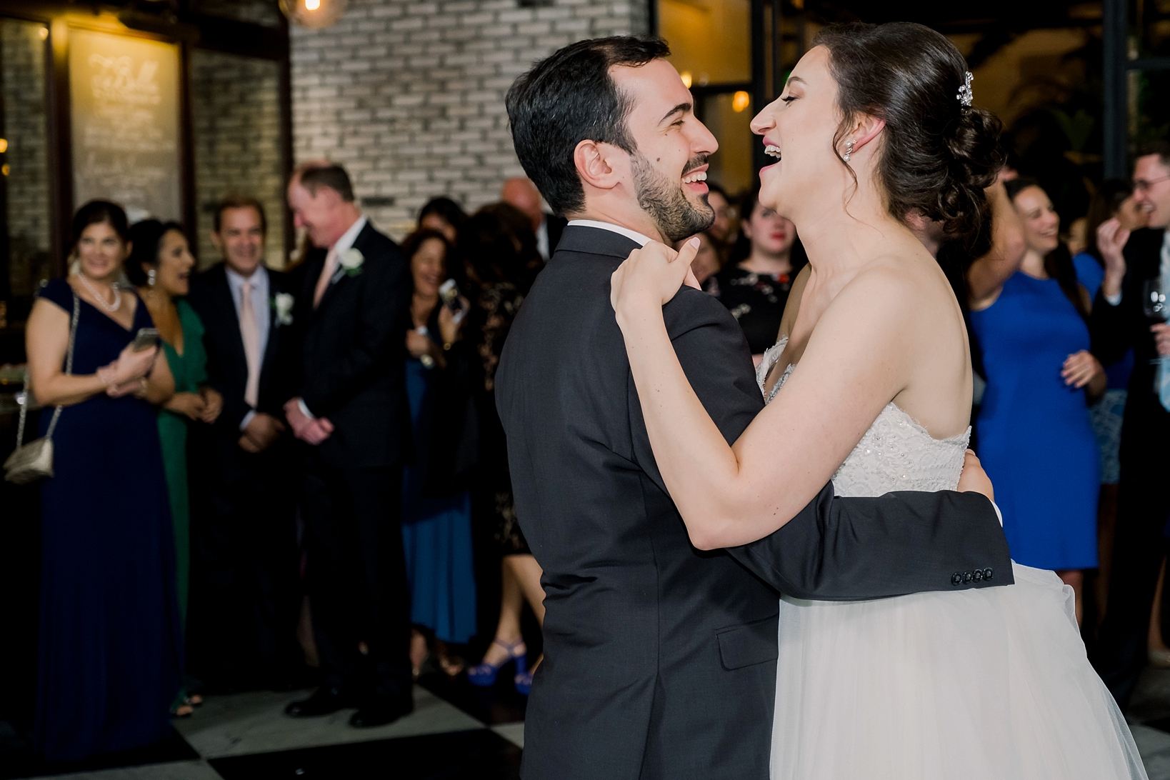 Bride and Groom surrounded by their friends and family during their first dance by Sarah and Ben Photography