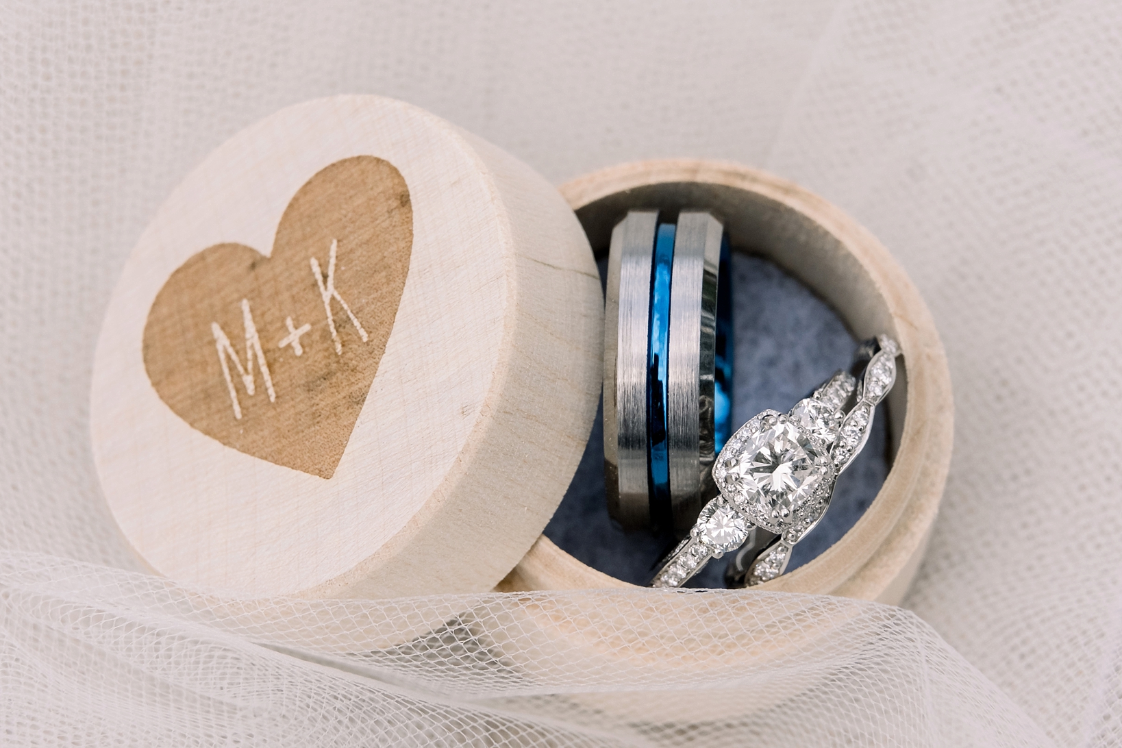 Th Bride and Grooms wedding rings in a custom wood box by Sarah & Ben Photography