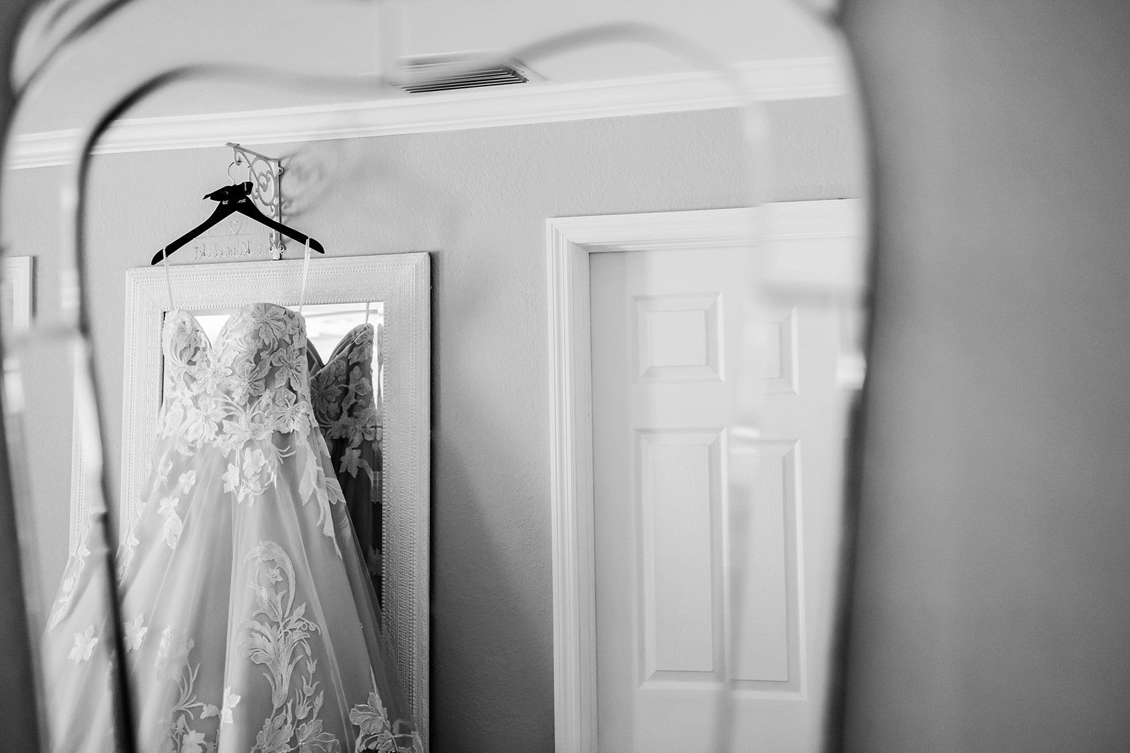 The wedding dress in the reflection of a mirror in timeless black and white photography