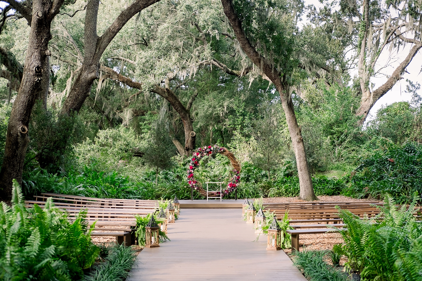 cross creek wedding ceremony in the enchanted forest with large floral circle