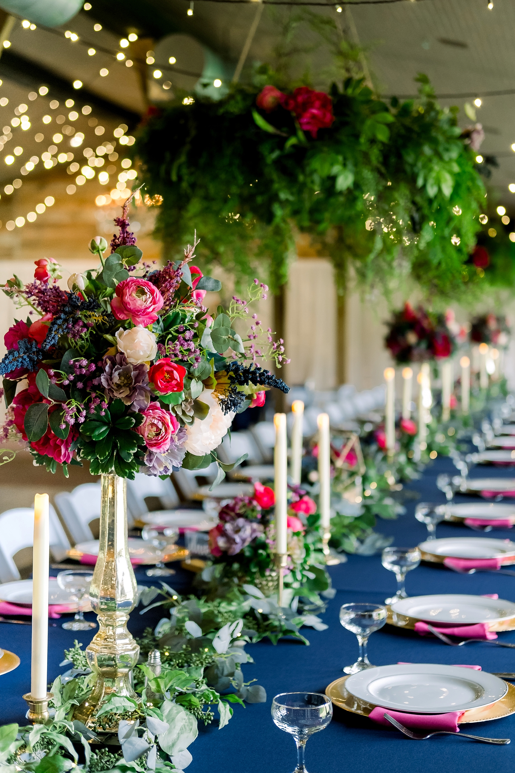 Beautifully decorated feasting tables at this cross creek wedding reception inside the barn by Sarah and Ben Photography