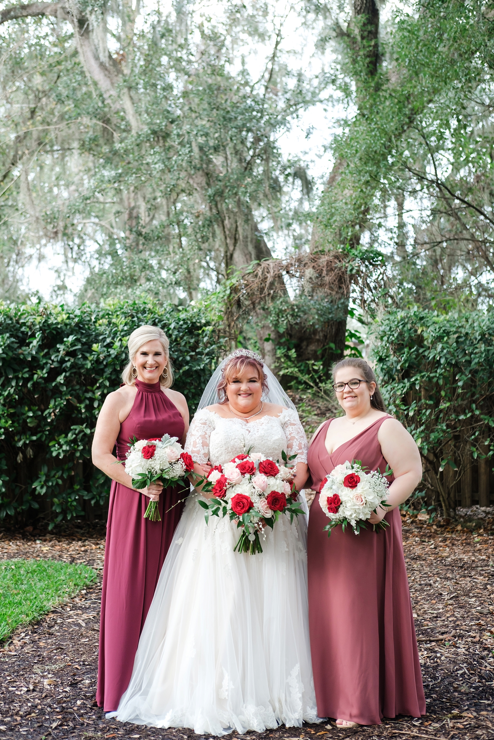 The Bride and her Bridesmaids pose under the ancient oaks of cross creek ranch