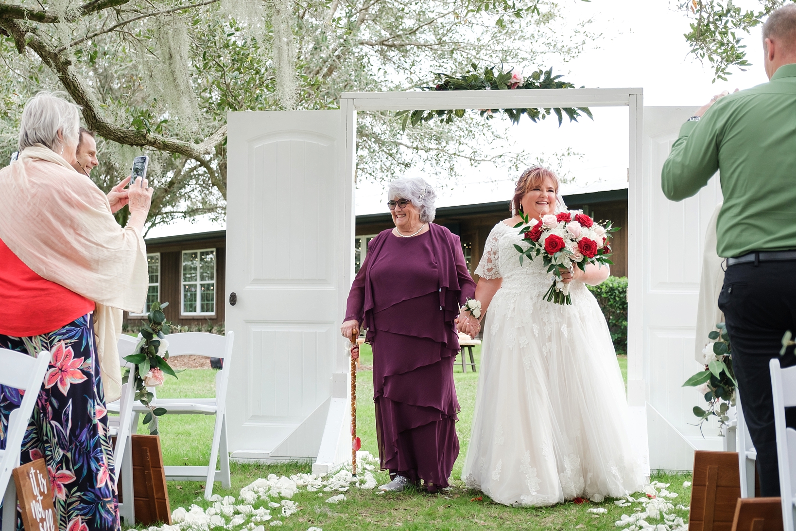 Bride and her Mother walk down the aisle together during her cross creek wedding celebration