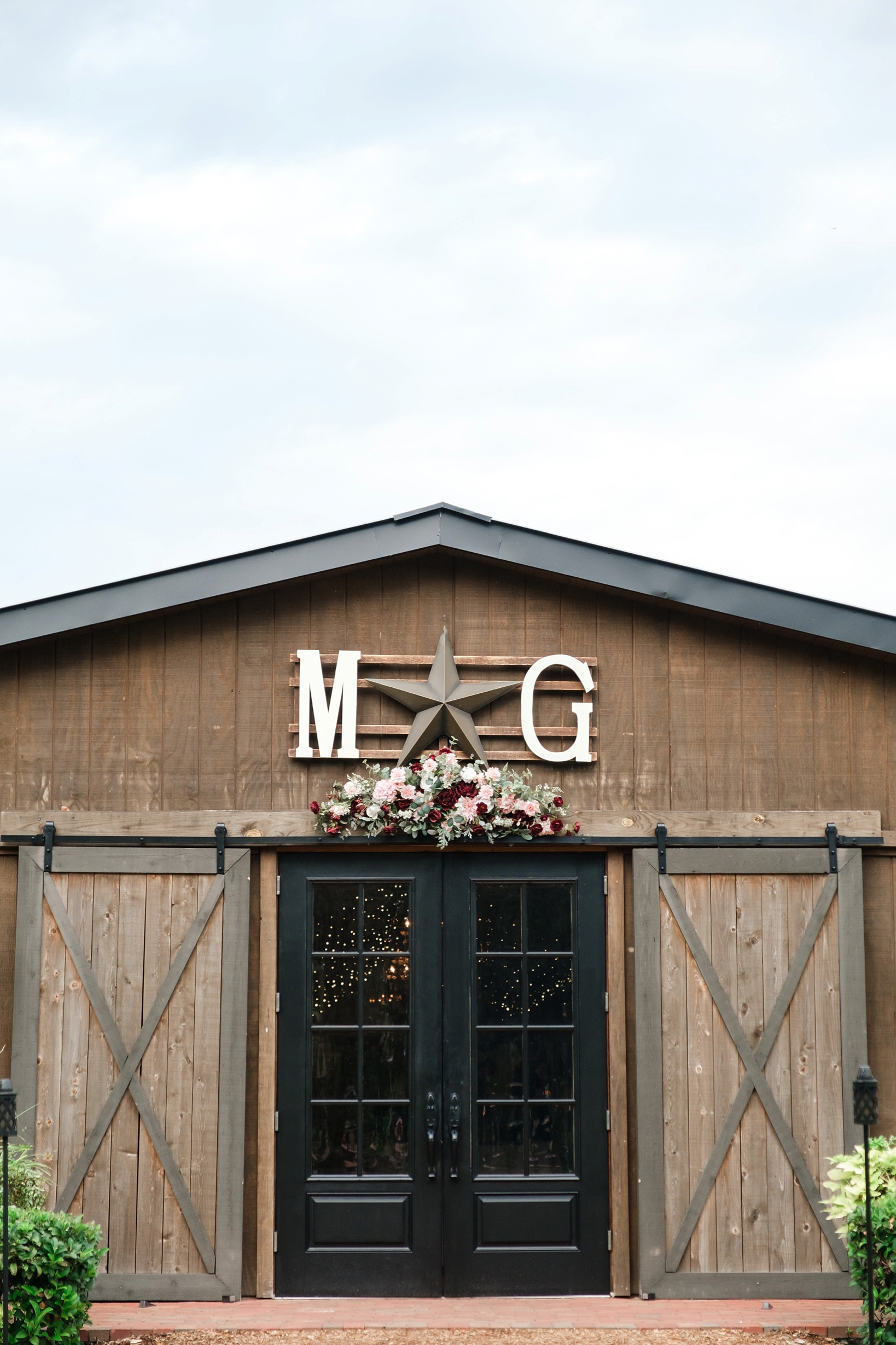Reception barn at cross creek ranch with Bride and Groom's initials over the doors