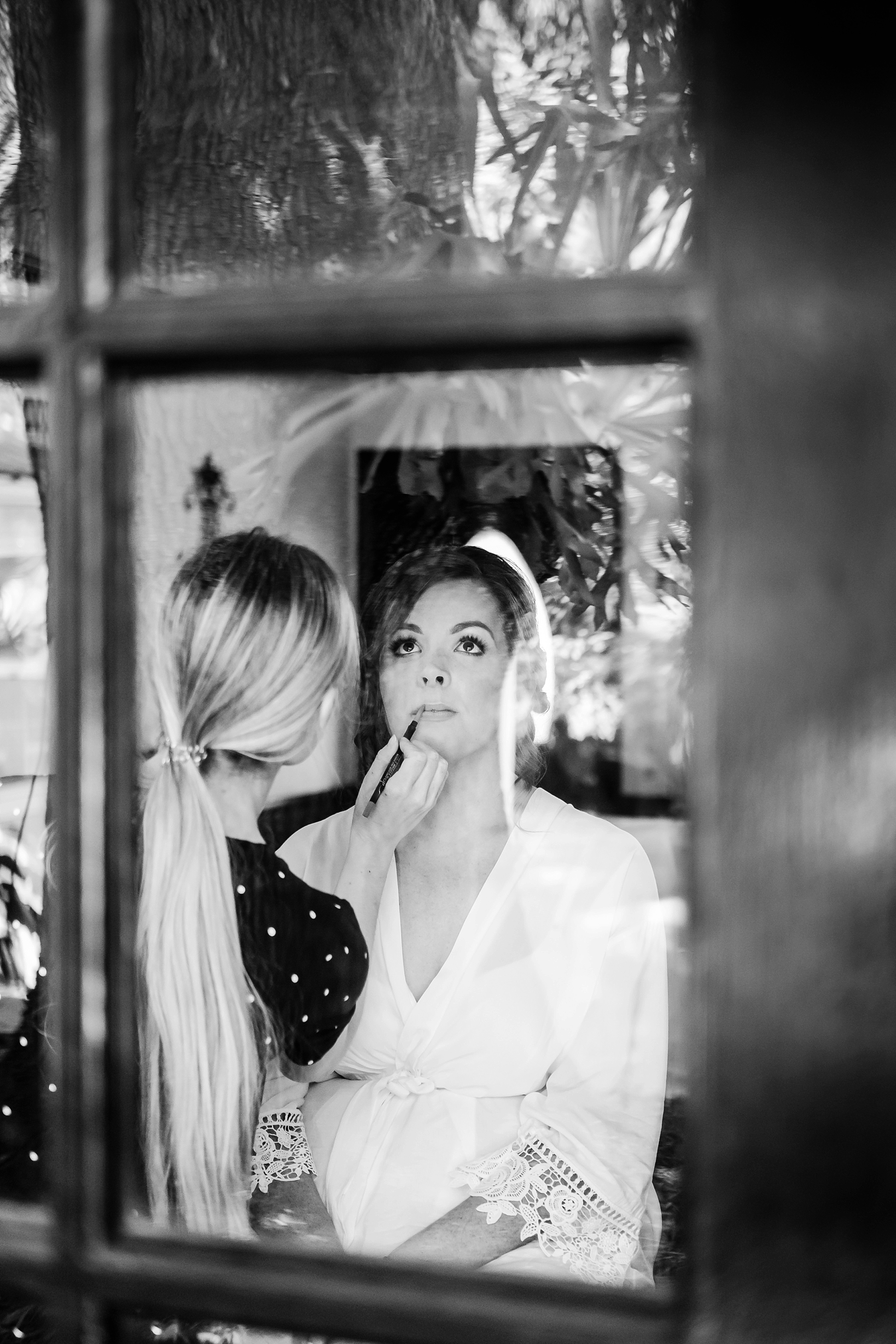 The Bride gets her finishing touches of her makeup done in the cottage of Cross Creek Ranch