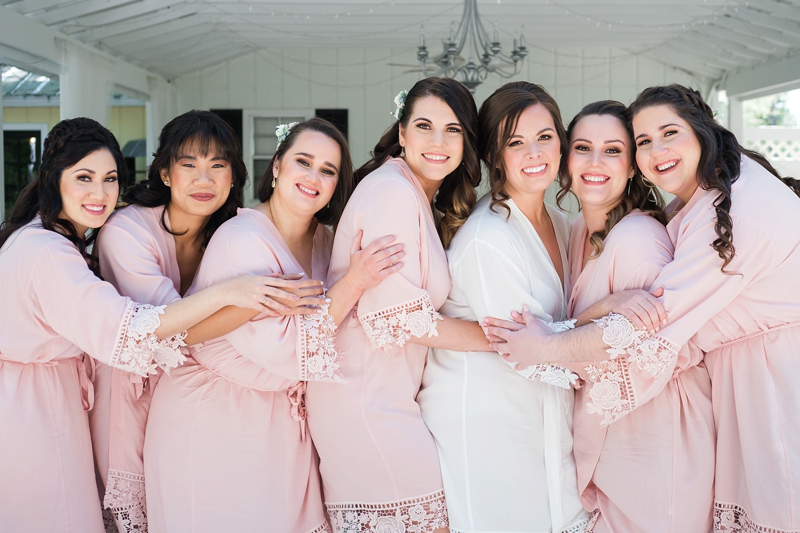 The Bride and her Bridesmaids share a big hug before her Cross Creek Ranch wedding
