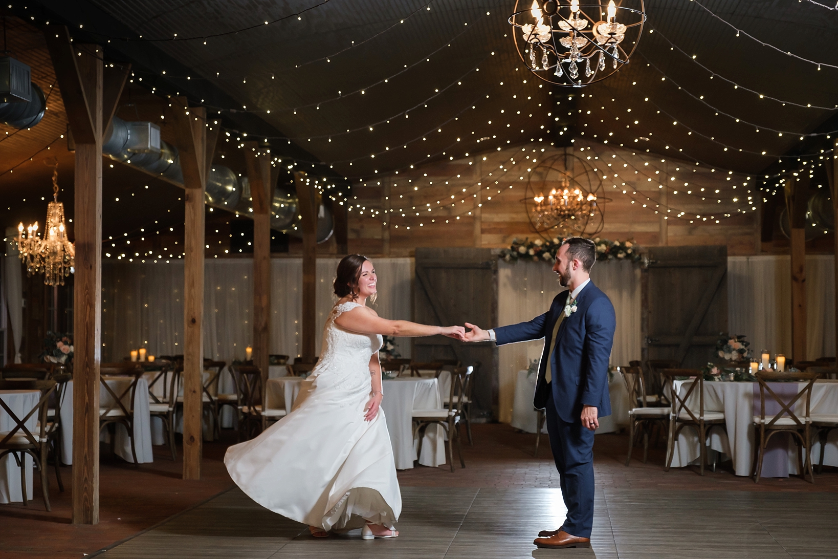 Bride and Groom share a quiet last dance together under the twinkle lights
