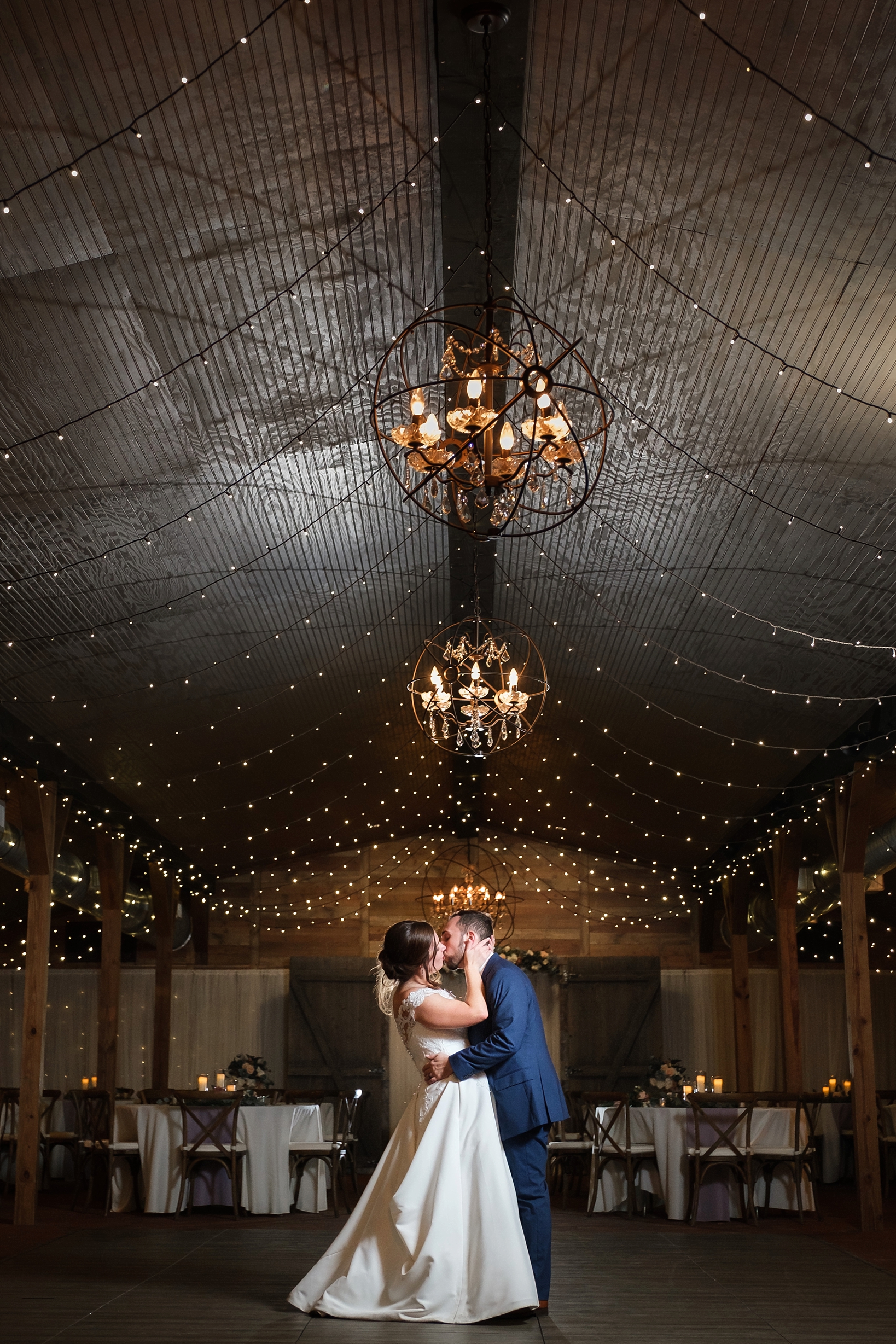 Bride and Groom kiss one last time during their wedding reception by Sarah and Ben Photography