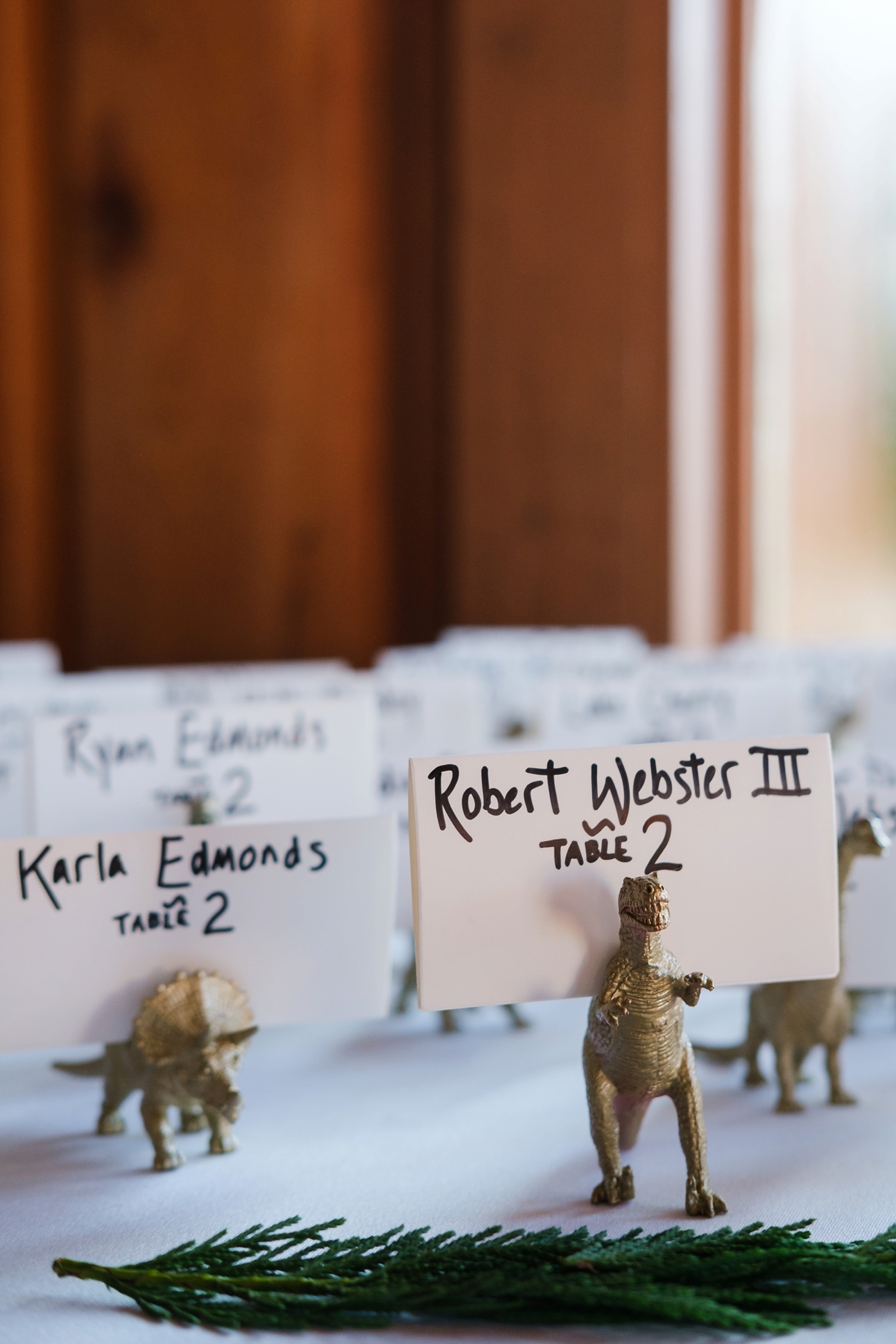 Table seating charts are decorated with hand-painted dinosaur figurines