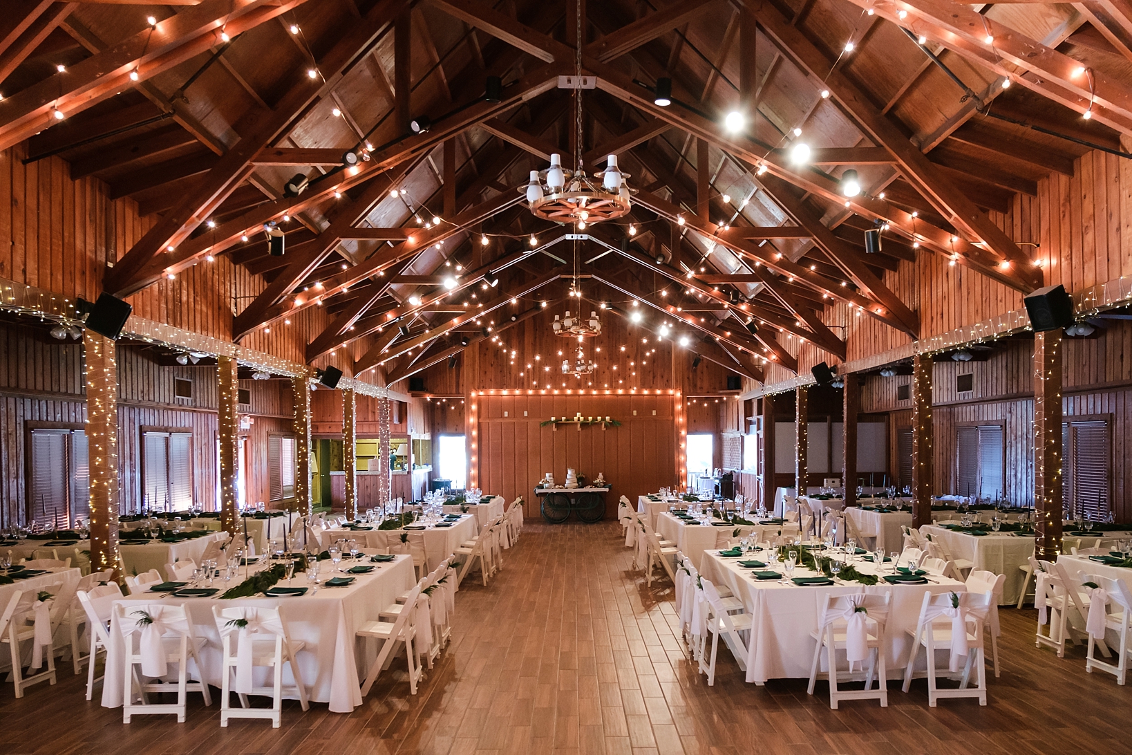 The reception space at the Westgate River Ranch barn complete with twinkle lights and chandeliers 