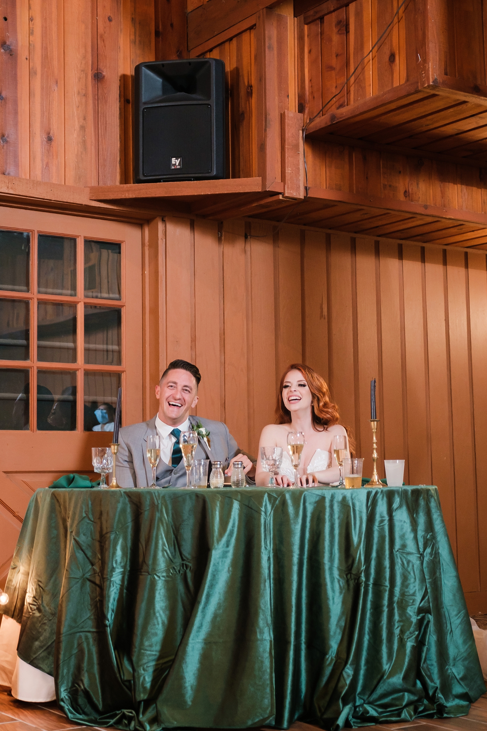 The Bride and Groom laughing during the speeches from their wedding party