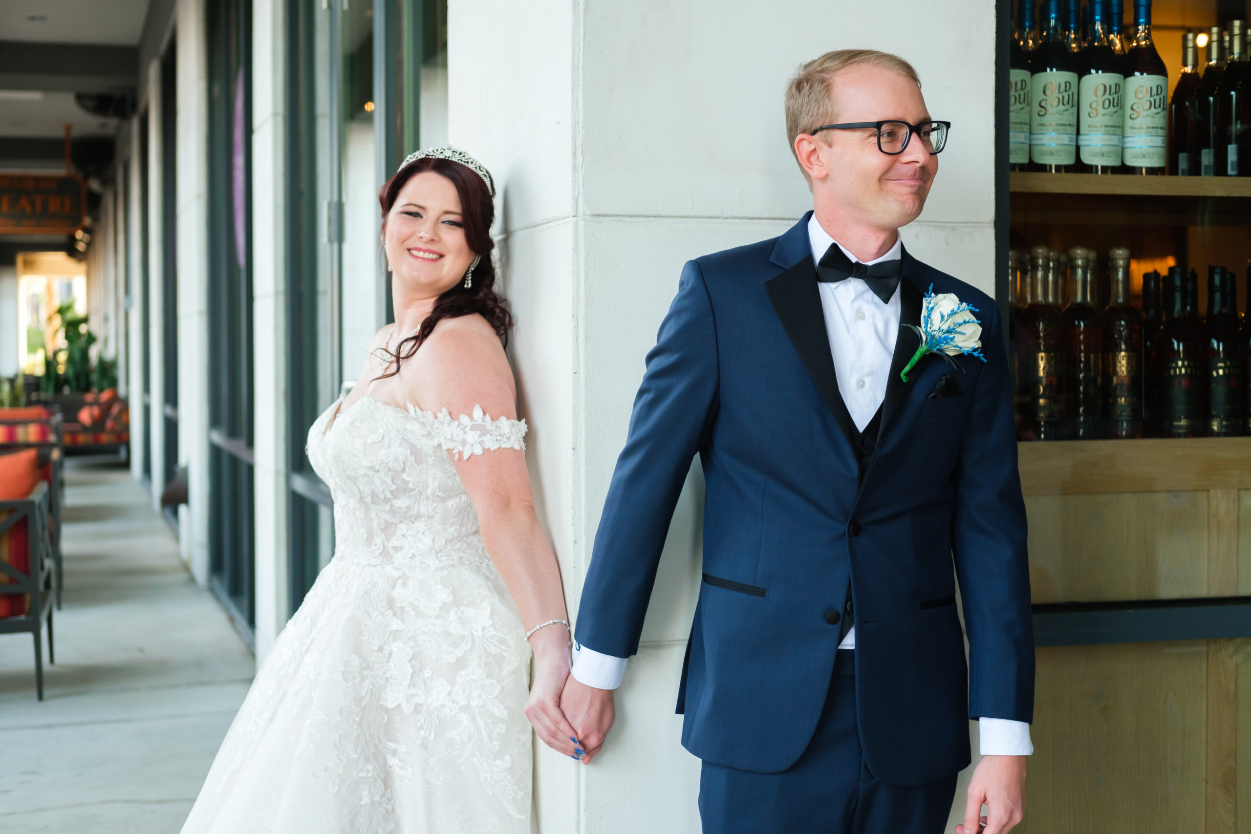 Bride and Groom holding hands around the corner of the Epicurean Hotel in Tampa, Florida
