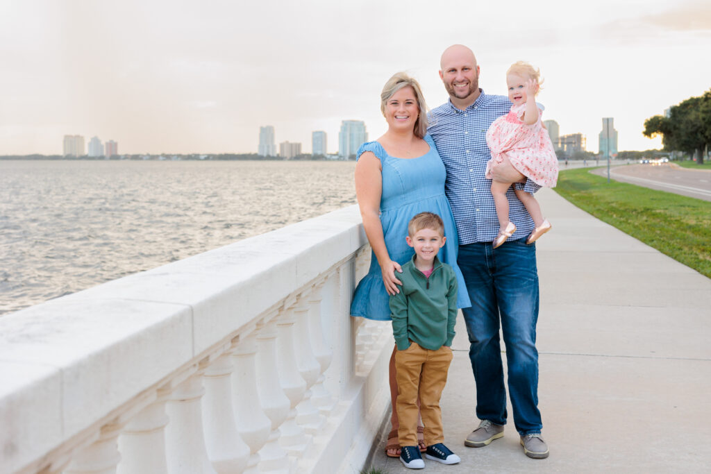 A family pose along the wall of Bayshore Blvd in South Tampa Florida