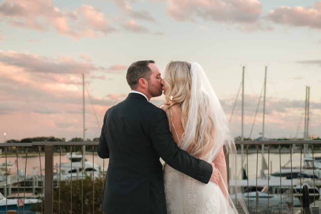 A Bride and Groom share a kiss on the balcony of the Vinoy St Petersburg, FL.